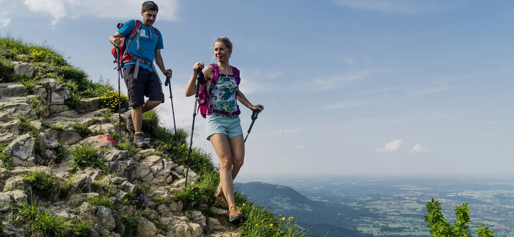 Abstieg: Zwei Wanderer auf den grünen Berghängen der Chiemgauer Alpen | © DAV/Hans Herbig